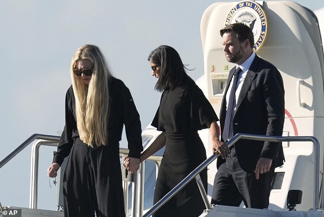 Vice President JD Vance, right, Second Lady Usha Vance, center, and Erika Kirk, holding a cross on a chain, deplane Air Force Two, carrying the body of Charlie Kirk, on Thursday