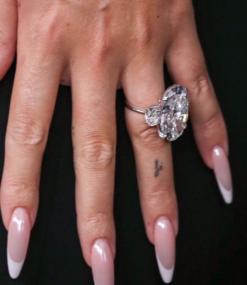 Close-up of a hand wearing a large diamond ring.