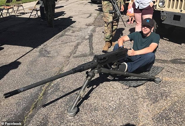 Other images also show Robinson using guns in his childhood, including one where he was posing with an M2 Browning 50. calibre machine gun