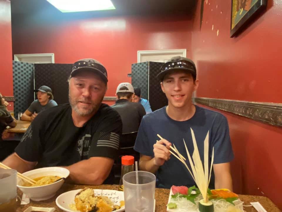 Two men eating at a restaurant.