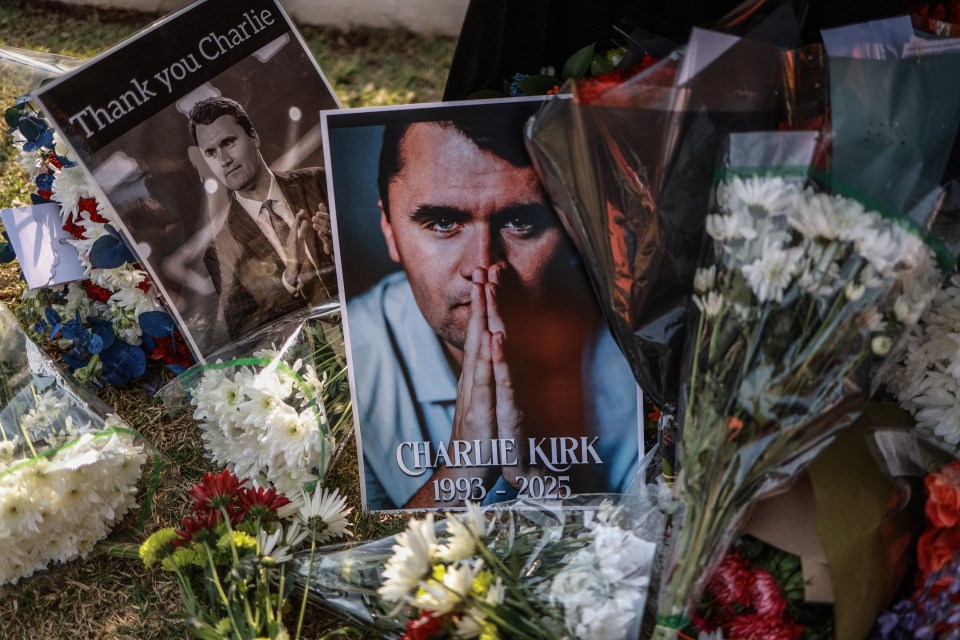 Flowers and photos of Charlie Kirk at a memorial.
