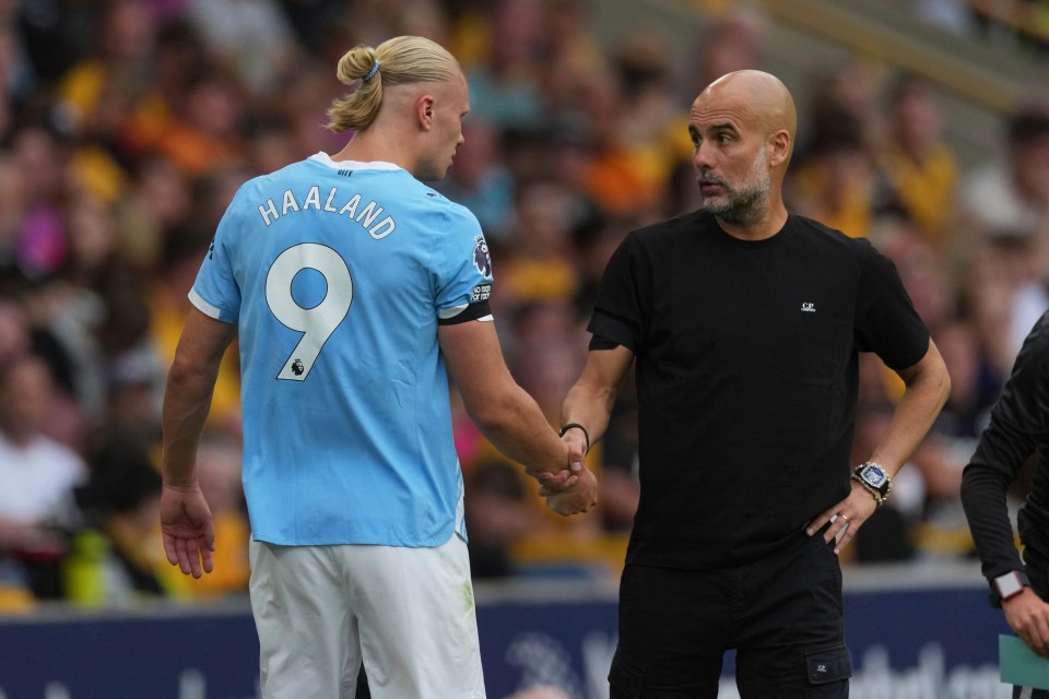 Pep Guardiola shaking hands with Erling Haaland.
