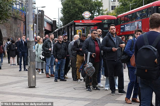 People queue for buses in Central London as the Tube strike caused travel misery