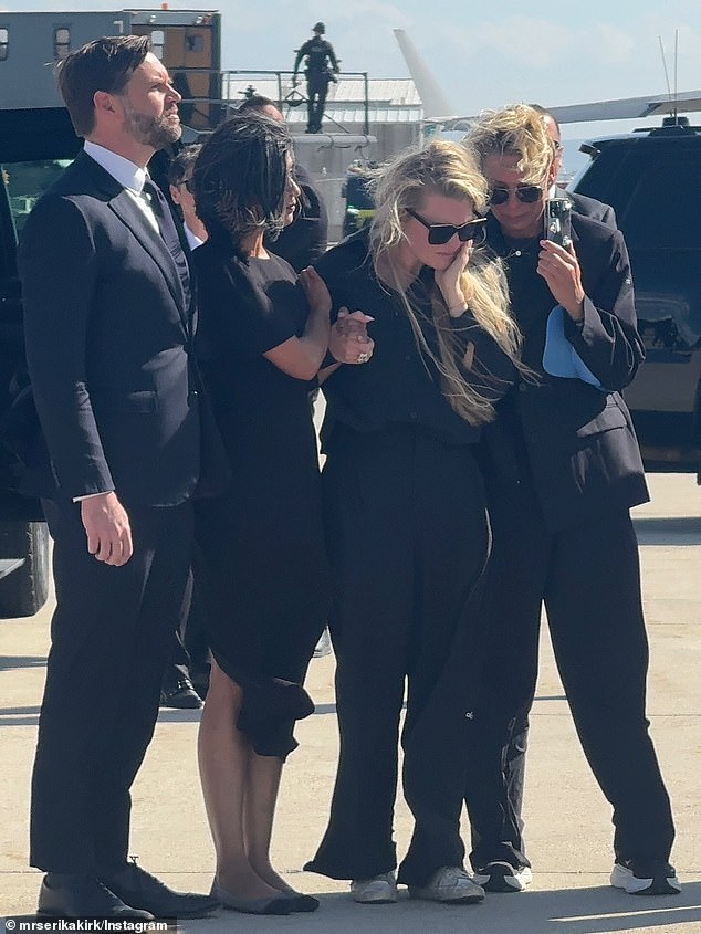 Erike also posted a series of photos of her on the tarmac to welcome her husband's body back to Arizona standing alongside JD Vance and his wife Usha, both seen left