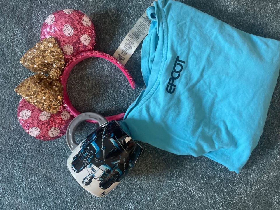 Minnie Mouse ears, Epcot shirt, and Star Wars mug.