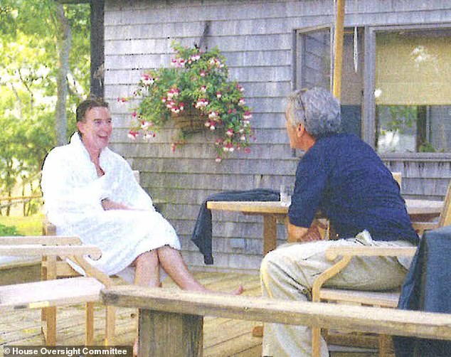 The holiday snap that triggered his downfall: Lord Mandelson in a fluffy white dressing gown enjoying a chat with 'best pal' Epstein