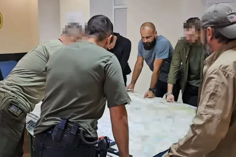A group of people looking at a map.