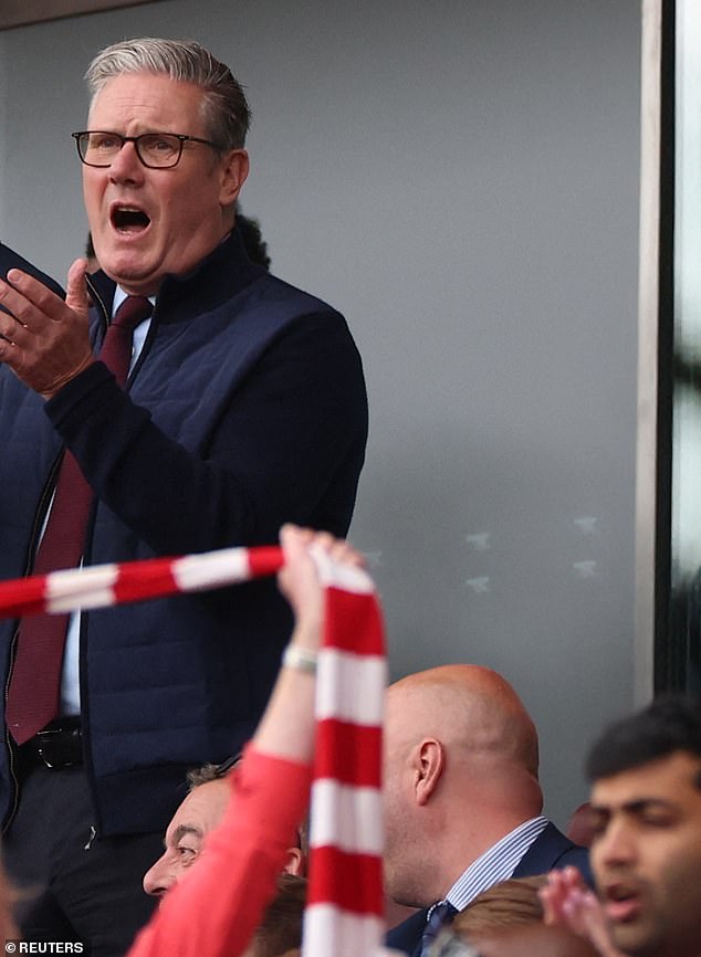 The Prime Minister attended the Arsenal match at the Emirates with his son while police prepared for thousands of angry protestors to descend upon central London