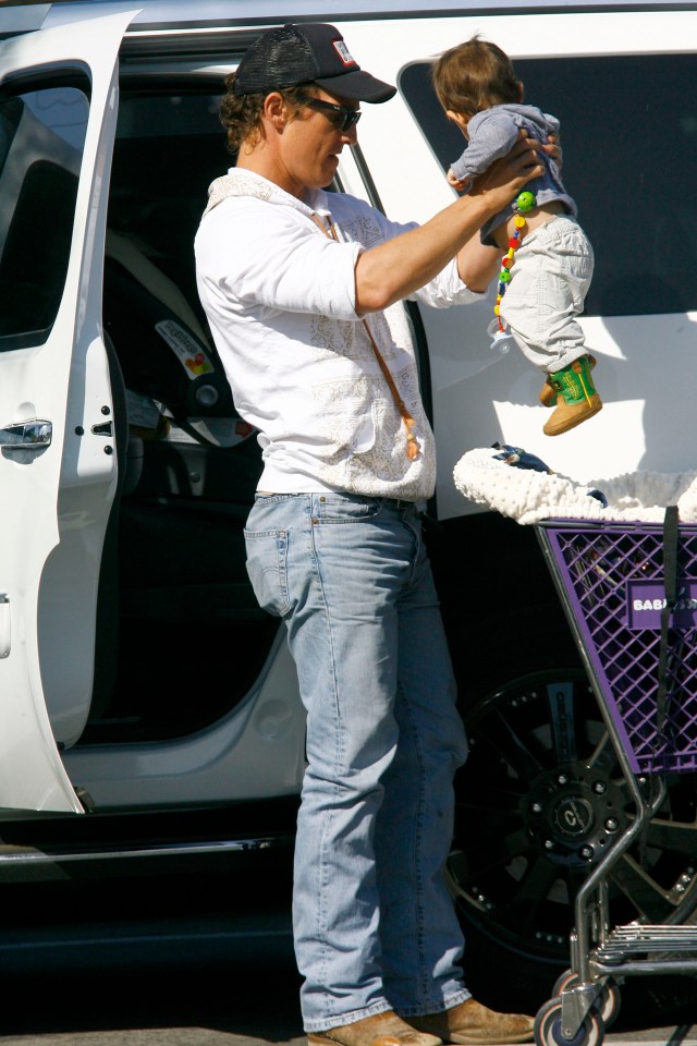 Matthew McConaughey holding his son while shopping.