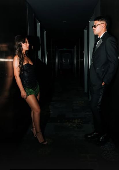 Conor and Megan in a dimly lit hallway.