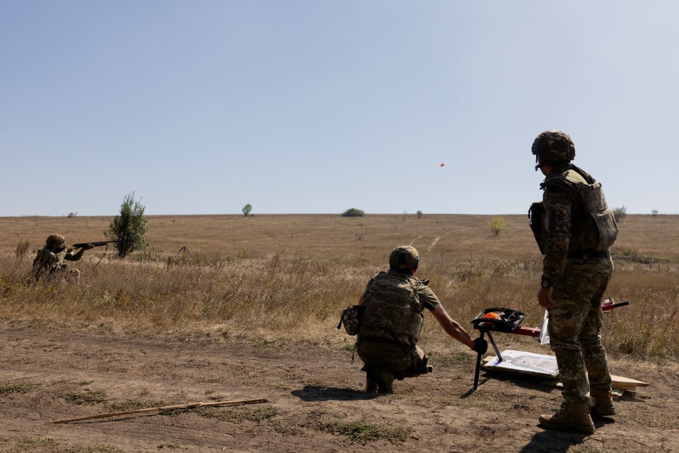 Ukrainian soldiers practicing shooting skills at a drone-destruction training exercise.