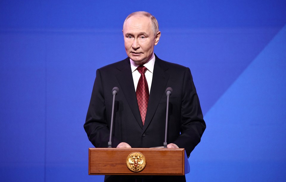 Vladimir Putin speaking at a podium.