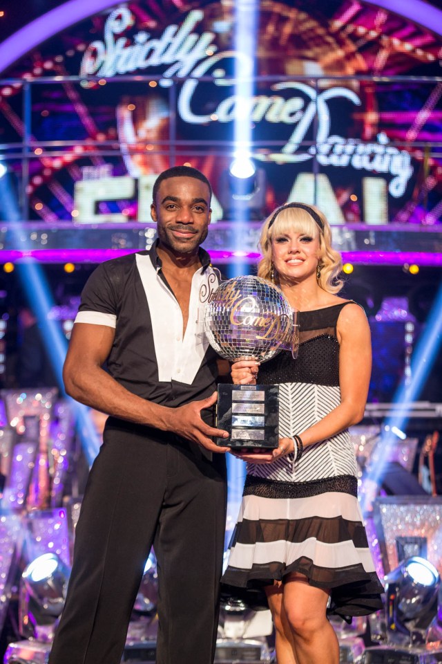 Joanne Clifton and Ore Oduba holding the Strictly Come Dancing glitterball trophy.