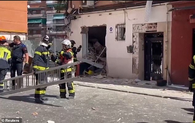 Pictured: Emergency responders work to clear the scene following the explosion