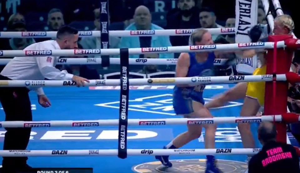Two female boxers fighting in a boxing ring.