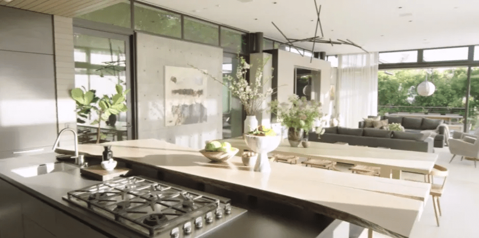Modern kitchen and living area with large windows.