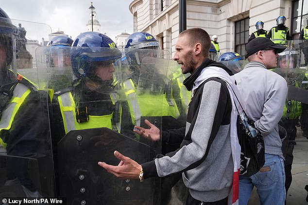 A person confronts police officers during the Tommy Robinson-led Unite the Kingdom march