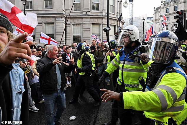 Police officers confront the supporters of British anti-immigration activist Stephen Yaxley-Lennon, also known as Tommy Robinson