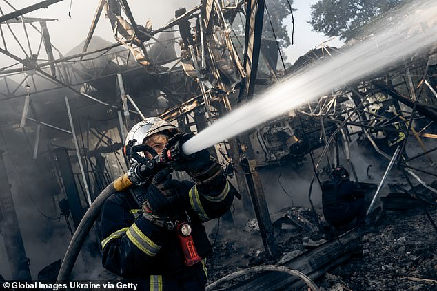 Firefighters work at the site of a Russian drone strike on September 12, 2025 in Sumy, Ukraine