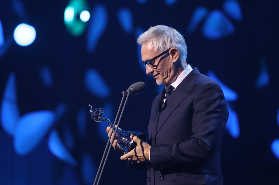Gary Lineker accepting an award on stage.