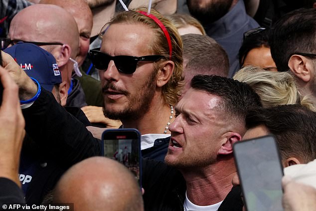 Actor and activist Laurence Fox (left) pictured in the crowd at the Unite The Kingdom' march next to Tommy Robinson (right)