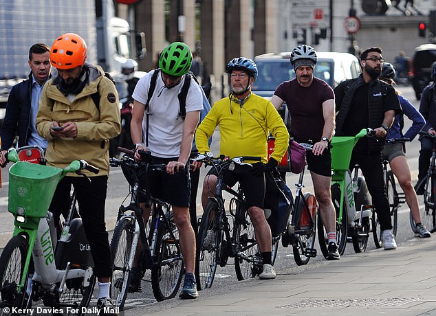 Cyclists pictured making their way to work in London this week during the Tube strike