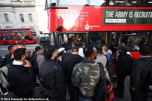 Despairing commuters packing onto buses into the city which are extremely busy with workers