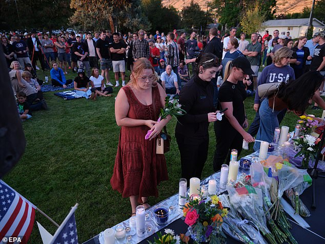 People attend a vigil honoring slain conservative political activist Charlie Kirk during an event in Provo, Utah, on Friday