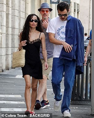 He draped a blue denim shirt over his shoulders and completed the look with off-white trainers and black sunglasses