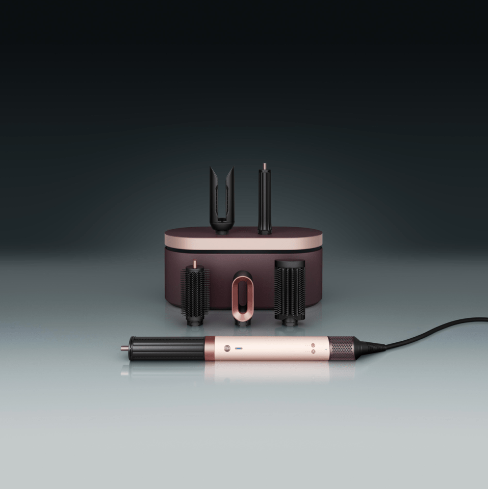 Dyson hair styling set with attachments and storage case.