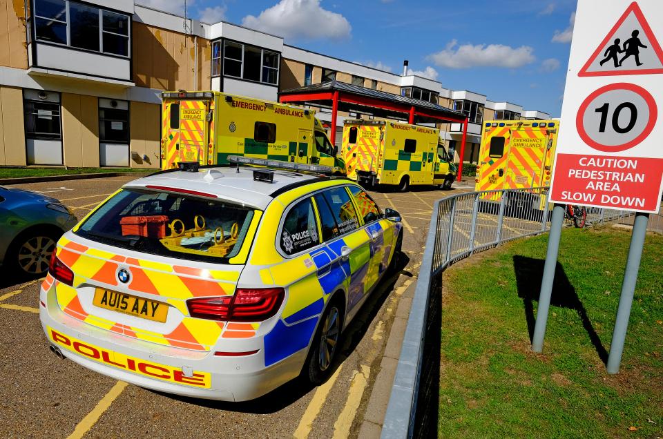 Police car and ambulances outside a hospital.