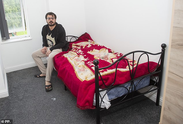 Dere's bedroom contains little furniture other than a bed which is decorated with red covers
