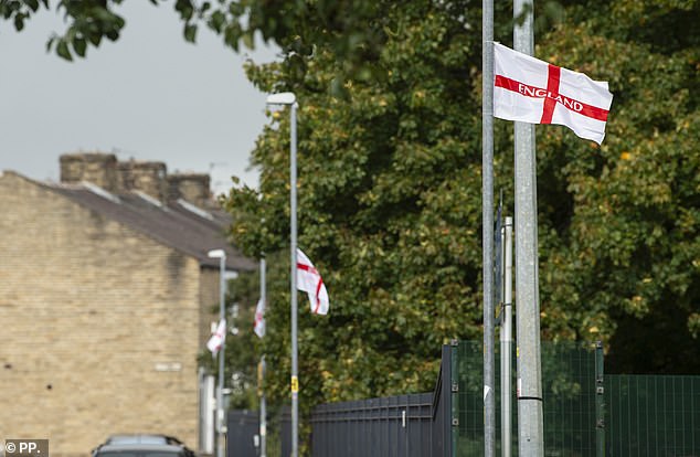 In the streets outside Dere's house, St George and Union flags flutter from lampposts as part of the political movement Operation Raise the Colours