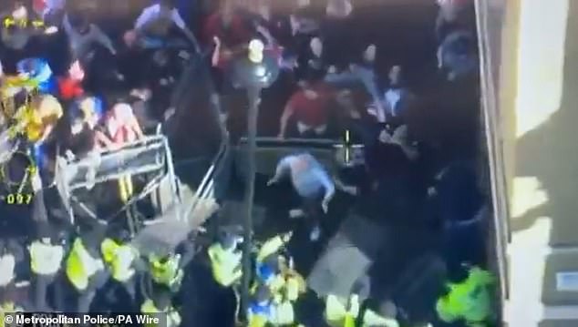 Overhead footage shared by the Met Police showed groups of protesters attempting to force their way through police barriers
