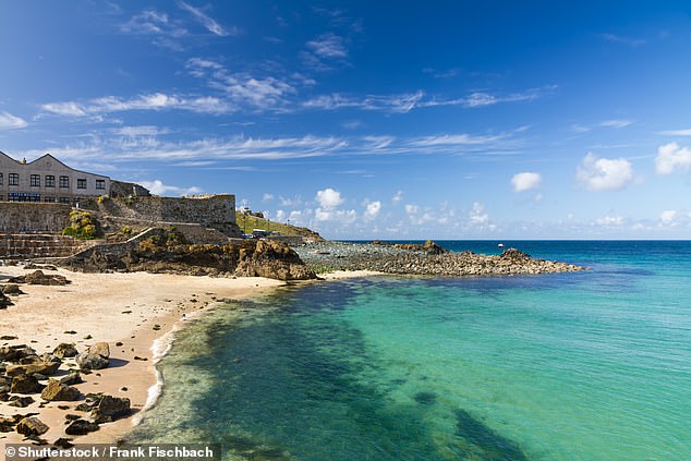Locals living in Cornwall's iconic seaside towns have long-complained of relentless crowds invading their quaint streets and landing en-masse on their beaches. Pictured: St Ives