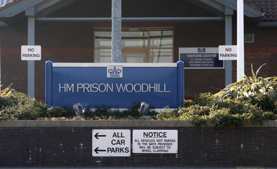 HM Prison Woodhill entrance sign and parking information.