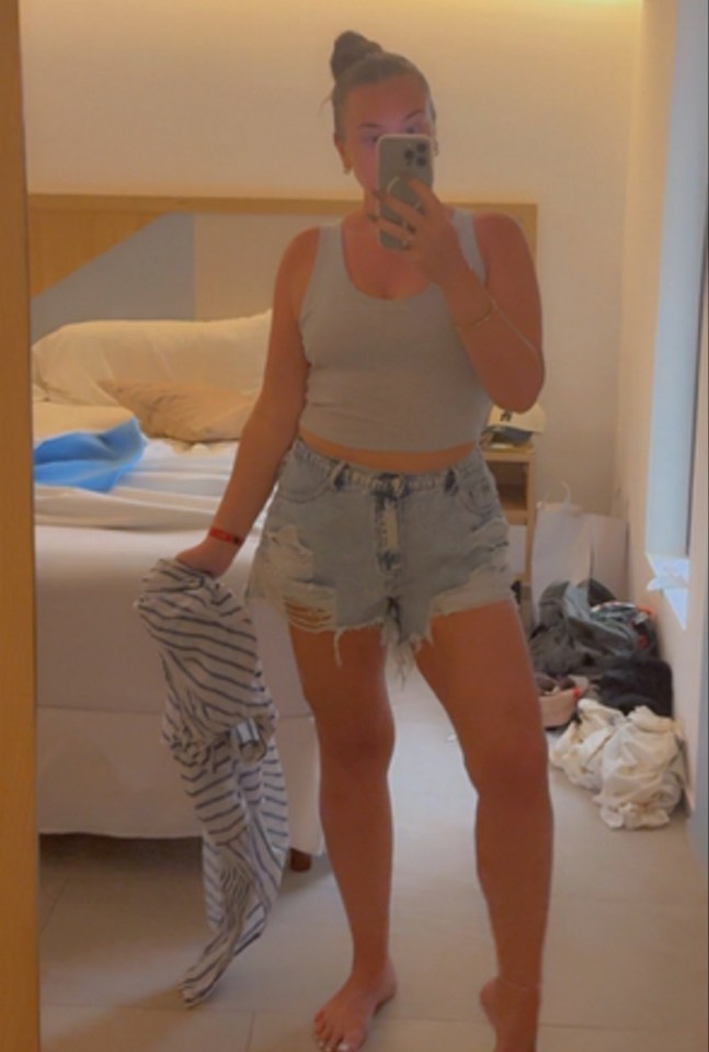 Woman taking a selfie in a hotel room.