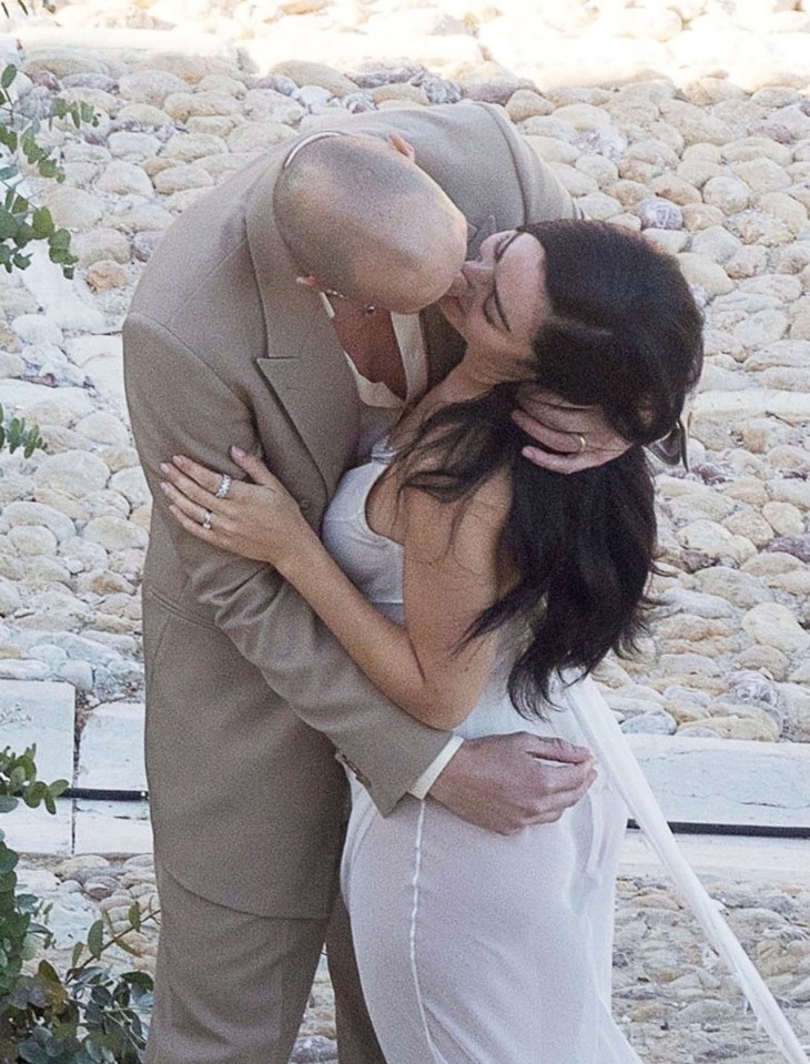 Charli XCX and George Daniel kissing at their wedding.