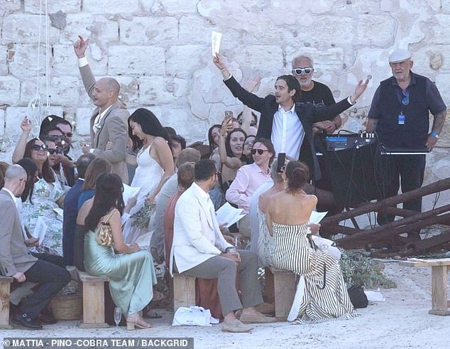 The newlyweds looked emotional as they said 'I do' all over again and exchanged rings in front of their loved ones, including George's bandmate Matty Healy and his mother Denise Welch