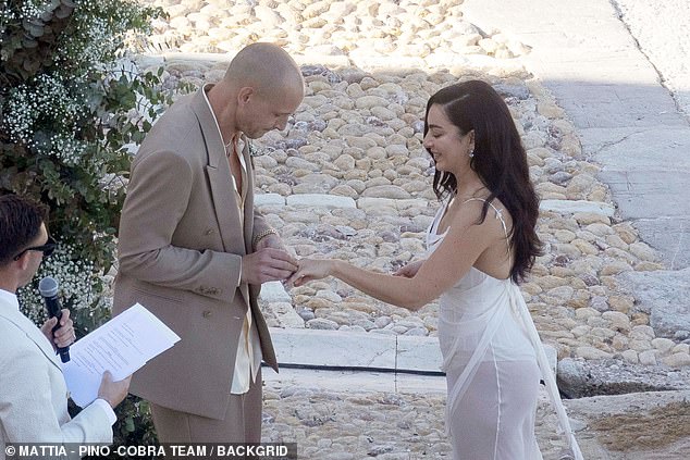Charlie looked on cloud nine as her new husband placed the ring on her wedding finger