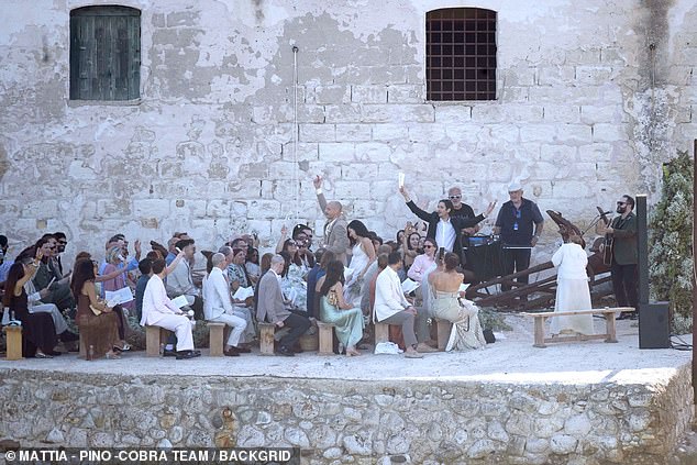 The romantic ceremony took place on a rocky outcrop right next to the idyllic sea, with rows of chairs laid out in front of an altar adorned with sprigs of eucalyptus leaves and baby's breath