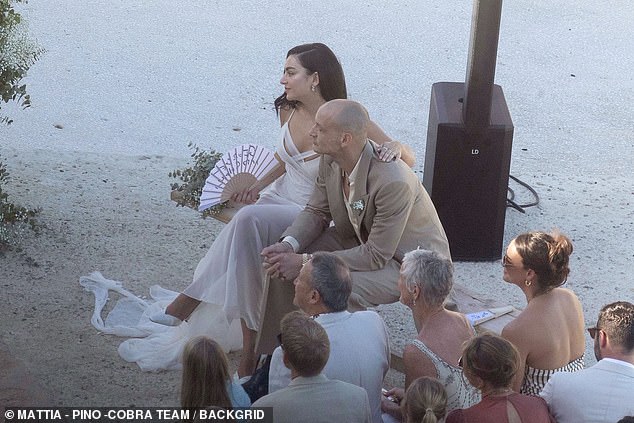 While the couple cooled themselves off with a personalised folding fan, that was emblazoned with the words: 'George and Charli'