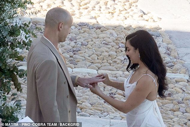 While George gazed at her with the look of love as she returned the favour and placed his own ring on his left hand