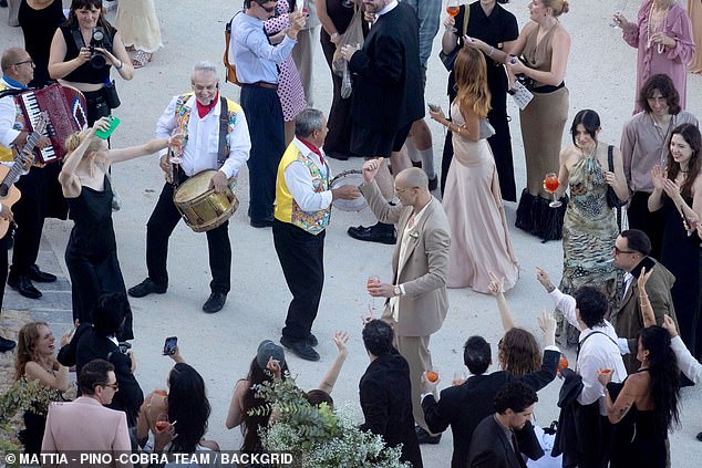 They were seen letting loose to the sounds of a live band, dancing and laughing while cocktails and drinks flowed