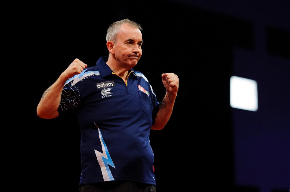 Phil Taylor celebrating a darts match victory.