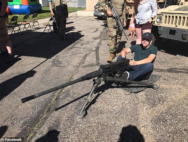 Robinson posing with a machine gun in a picture posted by his mother on Facebook
