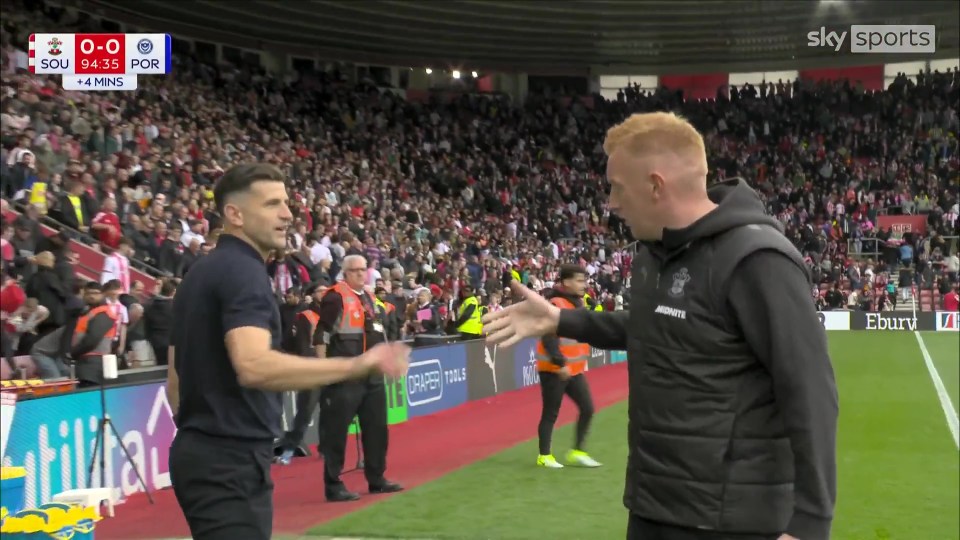 John Mousinho and Will Still shaking hands.