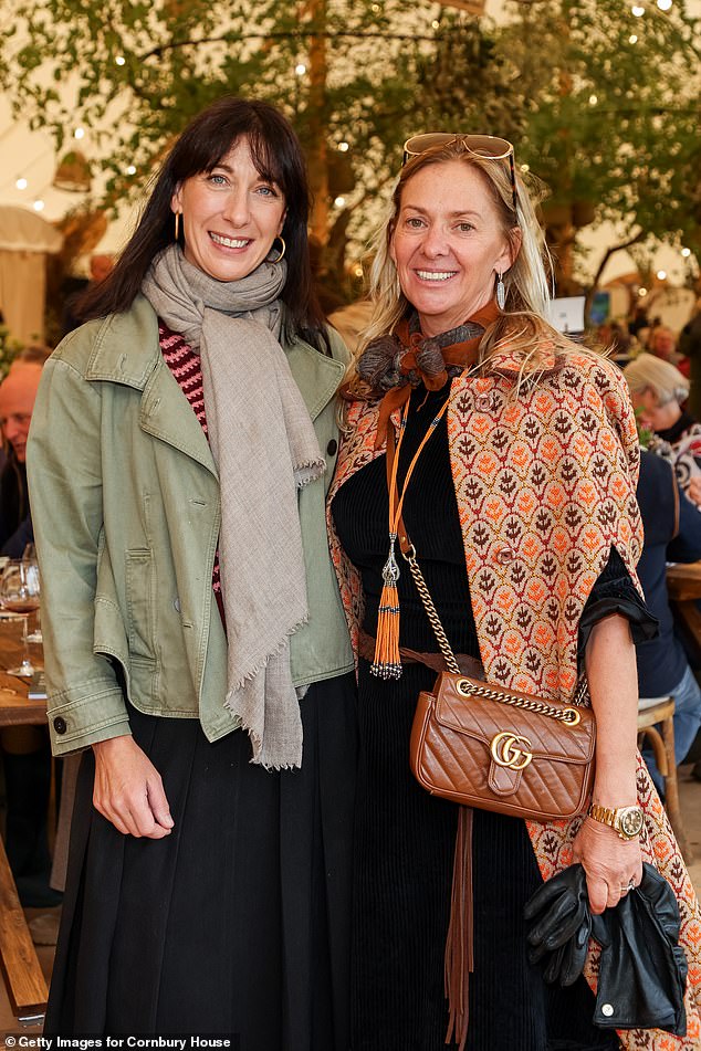 Samantha stepped out in a sage green trench coat and a long bellowing navy skirt, paired with a patterned sweater