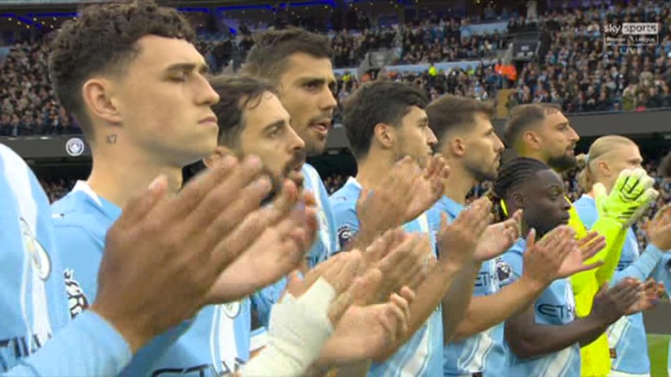 Manchester City players applauding.