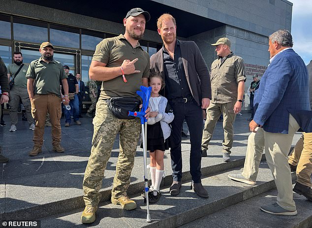 Harry poses for a picture with wounded Ukrainian serviceman Vasyl, 38, at the National Museum of the History of Ukraine in the Second World War -- September 12, 2025